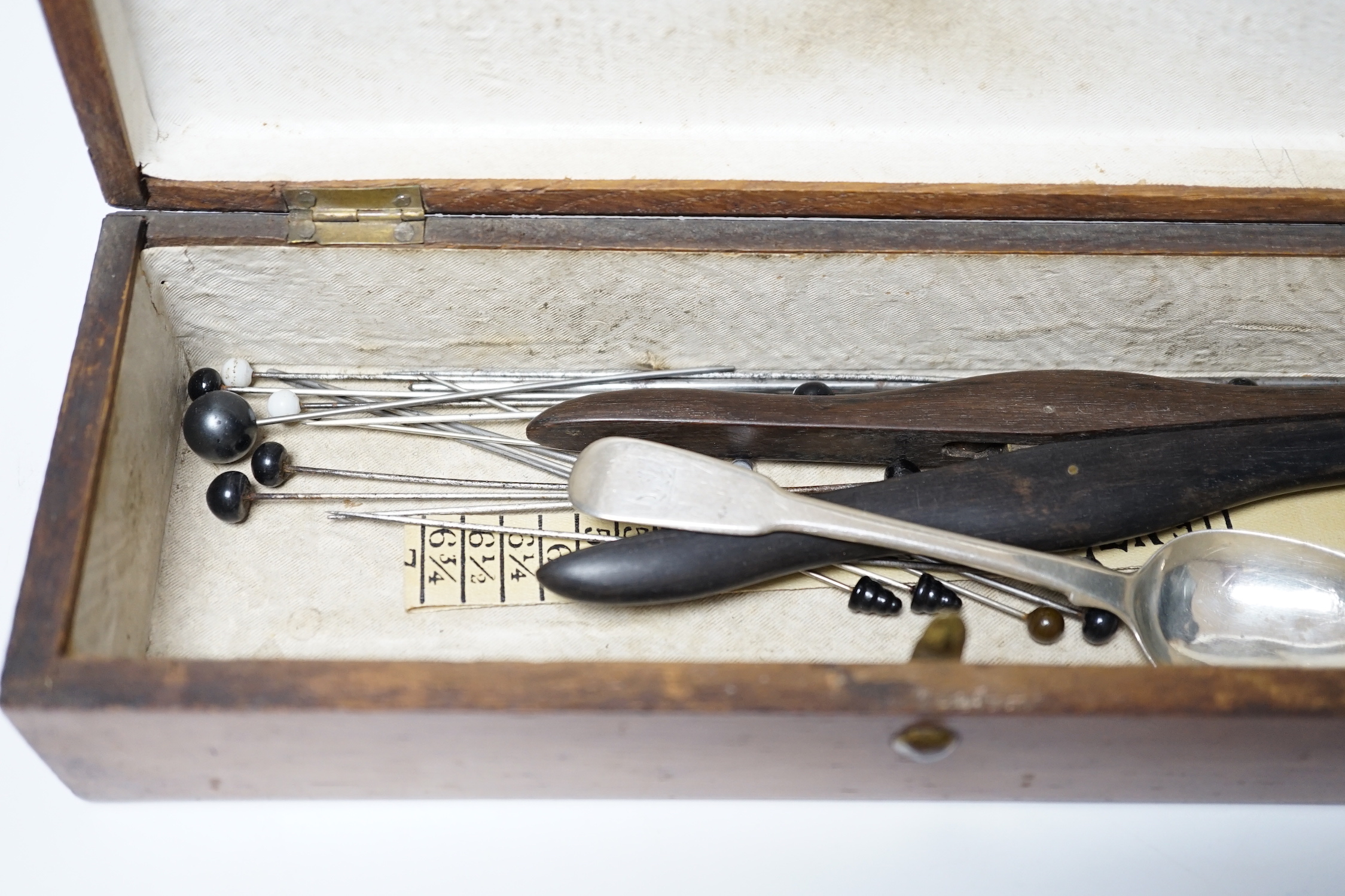 A glove box containing a boxwood foot-measure, two candle snuffers, a silver teaspoon etc